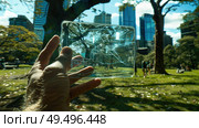 A close-up of a cracked glass pane held against a park vista, blending nature and urban architecture under a clear sky. Стоковое AI-изображение, AI-художник Данила Большаков / Фотобанк Лори