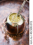 Yerba mate in calabash and dry herb.Traditional argentinian beverage. Yerba mate tea in a calabash gourd. Стоковое фото, агентство Ingram Publishing / Фотобанк Лори