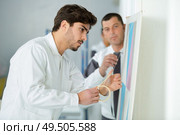 male painter using masking tape. Стоковое фото, агентство Ingram Publishing / Фотобанк Лори