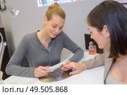 woman hands being nail filed by manicurist. Стоковое фото, агентство Ingram Publishing / Фотобанк Лори