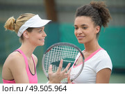 two of attractive smiling female tennis players standing outdoor. Стоковое фото, агентство Ingram Publishing / Фотобанк Лори