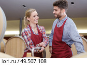 workers in wine cellar filling oak barrels. Стоковое фото, агентство Ingram Publishing / Фотобанк Лори