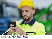 man with hard helmet talking on the phone. Стоковое фото, агентство Ingram Publishing / Фотобанк Лори