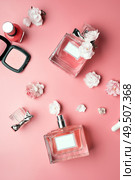 lady set with cosmetics and flowers around pink background. flat lay. Стоковое фото, агентство Ingram Publishing / Фотобанк Лори