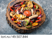Grilled sausages fried with pear and vegetables. Autumn food.. Fried sausages with sauces. Стоковое фото, агентство Ingram Publishing / Фотобанк Лори