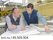 two careful workmen work at pvc windows factory. Стоковое фото, агентство Ingram Publishing / Фотобанк Лори