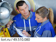 male and female engineers repairing aircraft. Стоковое фото, агентство Ingram Publishing / Фотобанк Лори