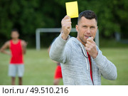 referee on football field showing yellow card. Стоковое фото, агентство Ingram Publishing / Фотобанк Лори
