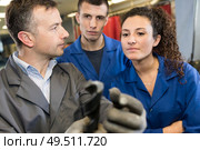 portrait of young mechanics at work. Стоковое фото, агентство Ingram Publishing / Фотобанк Лори