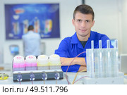 Young man with pots of ink. Стоковое фото, агентство Ingram Publishing / Фотобанк Лори