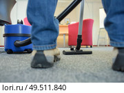 Closeup of vacuum and feet of person using it. Стоковое фото, агентство Ingram Publishing / Фотобанк Лори