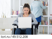 young woman on the wheelchair using her laptop. Стоковое фото, агентство Ingram Publishing / Фотобанк Лори