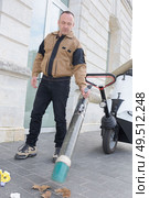 man using suction machine to clean city streets. Стоковое фото, агентство Ingram Publishing / Фотобанк Лори