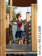 Little girl, eight years old, having fun in an urban playground.. Little girl, eight years old, having fun outdoors. Стоковое фото, агентство Ingram Publishing / Фотобанк Лори