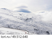 Spain, Andalusia, Granada. Ski resort of Sierra Nevada in winter, full of snow with lenticular clouds in the sky. Travel and sports concepts.. Ski resort of Sierra Nevada in winter, full of snow. Стоковое фото, агентство Ingram Publishing / Фотобанк Лори