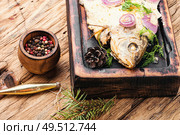 Baked fish at the Christmas table.Holiday food.Baked crucian.Fish food.. Baked fish for christmas. Стоковое фото, агентство Ingram Publishing / Фотобанк Лори