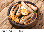 Grilled sausages and vegetables on wooden table.Bbq food. Grilled sausages with vegetables. Стоковое фото, агентство Ingram Publishing / Фотобанк Лори