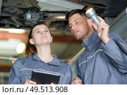 man and woman auto mechanics in a car workshop. Стоковое фото, агентство Ingram Publishing / Фотобанк Лори