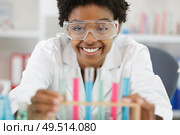 happy woman with glasses holds multicolored liquids. Стоковое фото, агентство Ingram Publishing / Фотобанк Лори