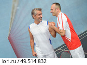 middle-age badminton players happy after winning competiton. Стоковое фото, агентство Ingram Publishing / Фотобанк Лори