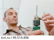 Changing a drill bit. Стоковое фото, агентство Ingram Publishing / Фотобанк Лори