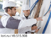 technician checking the state of water pipes indoors. Стоковое фото, агентство Ingram Publishing / Фотобанк Лори