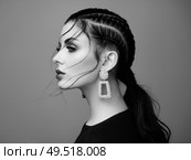 Brunette girl with perfect makeup. Beautiful model woman with curly hairstyle. Care and beauty hair products. Lady with braided hair. Model with jewelry. Black and white photo. Стоковое фото, агентство Ingram Publishing / Фотобанк Лори