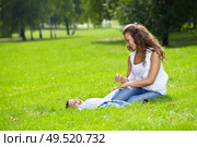 Happy mum with son on a lawn in park. Стоковое фото, агентство Ingram Publishing / Фотобанк Лори