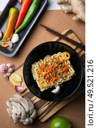 cooking spicy instant noodles soup with shrimps and  mushrooms. flat lay. . Стоковое фото, агентство Ingram Publishing / Фотобанк Лори