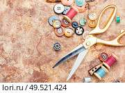 Sewing tools, scissors, many buttons and threads.Space for text. Tools for sewing. Стоковое фото, агентство Ingram Publishing / Фотобанк Лори