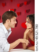 Conversation of two flirting enamoured on a red background. Стоковое фото, агентство Ingram Publishing / Фотобанк Лори