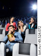 Enamoured girls admire the attractive man at cinema. Стоковое фото, агентство Ingram Publishing / Фотобанк Лори