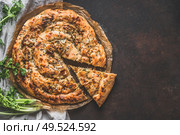 Turkish savory pie with Phyllo dough. Su boregi, burek or borek on dark rustic background. Top view. Стоковое фото, агентство Ingram Publishing / Фотобанк Лори