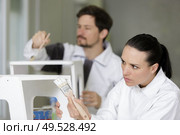 man and woman painting wooden objects in workshop. Стоковое фото, агентство Ingram Publishing / Фотобанк Лори