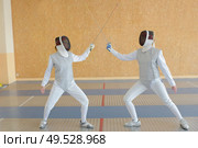a couple during fencing dual. Стоковое фото, агентство Ingram Publishing / Фотобанк Лори