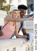 multiethnic traveller couple with local map pointing forwards. Стоковое фото, агентство Ingram Publishing / Фотобанк Лори