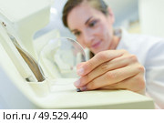 female doctor fixes glasses in the laboratory. Стоковое фото, агентство Ingram Publishing / Фотобанк Лори