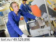 young qualified people forced to work at the factory. Стоковое фото, агентство Ingram Publishing / Фотобанк Лори