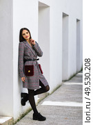 Young beautiful girl with very long hair looking at camera wearing winter coat and cap outdoors. Lifestyle and fashion concept.. Beautiful girl with very long hair wearing winter coat and cap outdoors. Стоковое фото, агентство Ingram Publishing / Фотобанк Лори