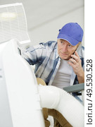 a man is checking an air conditioning maintenance problem. Стоковое фото, агентство Ingram Publishing / Фотобанк Лори