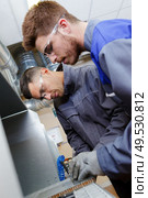 two men working on a machine. Стоковое фото, агентство Ingram Publishing / Фотобанк Лори