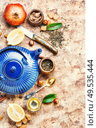 Natural ingredients for tea.Porcelain blue teakettle.Useful tea with lemon.. Tea with lemon. Стоковое фото, агентство Ingram Publishing / Фотобанк Лори