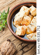 Feta cheese with herbs and garlic on old wooden background. Homemade feta cheese with herbs. Стоковое фото, агентство Ingram Publishing / Фотобанк Лори