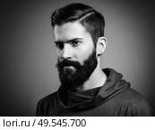 Portrait of handsome man with beard and mustache. Close-up image of serious brutal bearded man on dark background. Black and white photography. Стоковое фото, агентство Ingram Publishing / Фотобанк Лори