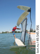 salior trying to right his catamaran after capsize. Стоковое фото, агентство Ingram Publishing / Фотобанк Лори