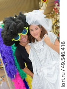 a couple is dressing up. Стоковое фото, агентство Ingram Publishing / Фотобанк Лори