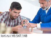 portrait of men fixing something. Стоковое фото, агентство Ingram Publishing / Фотобанк Лори