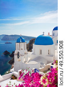 volcano caldera with blue church domes and belfry, Oia village, Santorini. view of caldera with blue domes, Santorini. Стоковое фото, агентство Ingram Publishing / Фотобанк Лори