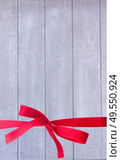 textutre of weathered gray wooden planks  with red bow background. wooden planks. Стоковое фото, агентство Ingram Publishing / Фотобанк Лори