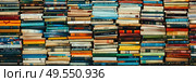 Various books arranged in a stacked formation, creating a tall and structured tower of literature. Стоковое AI-изображение, AI-художник Данила Большаков / Фотобанк Лори